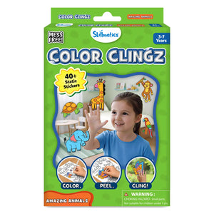 Front packaging of Skillmatics Color Clingz Amazing Animals for ages 3–7, shown in a bright green box. The pack highlights “Mess Free” play and “40+ Static Stickers.” A smiling child is pictured applying colorful animal stickers to a window, including a giraffe, elephant, monkey, turtle, and parrot. Icons at the bottom show the steps: color, peel, and cling, with a safety warning printed below.