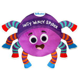 A front-facing view of the Skillmatics Incy Wincy Spider plush toy on a white background. The spider has a round purple body with a smiling embroidered face, large stitched eyes, and the words “Incy Wincy Spider” stitched across the top. Eight soft, striped legs in bright colors extend outward, showing varied fabric textures designed for gripping, squeezing, and sensory exploration by babies and toddlers.