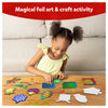 Child creating colorful holiday-themed foil art on Christmas ornament shapes with Foil Fun kit