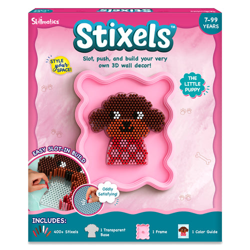 Front packaging of Skillmatics Stixels 3D wall décor craft kit for ages 7–99, showing pink box with 'Stixels' branding and a pixel-style puppy design built using cylindrical stixel pegs in a pink frame. Text highlights slot, push, build 3D decor, includes 400+ stixels, base, frame, color guide.