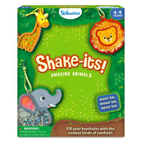 Front view of the Skillmatics “Shake-its! Amazing Animals” activity kit packaging in green jungle styling. The box shows illustrated animal foam keychain shapes including a giraffe, lion, and elephant filled with glitter confetti. Text includes the Skillmatics logo, age range 4–9 years, a warning about small parts, and the phrase “Make ’em, shake ’em, wear ’em,” along with jungle leaves and sparkle accents.