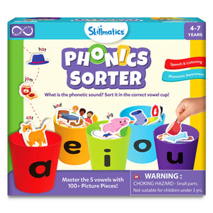 Skillmatics Phonics Sorter educational game box for ages 4 to 7, featuring five colorful cups labeled a, e, i, o, and u. Illustrated picture pieces like cat, bed, pig, jam, hat, and cup are shown being sorted into vowel cups. The box highlights phonemic awareness, speech and listening skills, includes 100 plus picture pieces, shows hands-on play, and displays a child-friendly, bright learning design.