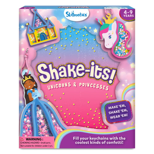 Front view of the Skillmatics “Shake-its! Unicorns & Princesses” activity kit box with a pastel pink, purple, and blue sky background. The packaging features foam shake-it designs including a unicorn head, a princess in a blue gown, and a castle, each filled with colorful confetti. Visible text includes the Skillmatics logo, age range 4–9 years, a “Make ’em, shake ’em, wear ’em” callout, and a small choking hazard warning.