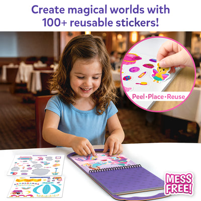 Smiling girl in blue shirt placing stickers into a purple Peelies spiral-bound activity book at a white table. A sticker sheet with princess-themed accessories lies beside the book. Circular inset shows a close-up of a hand peeling a butterfly cat sticker from a sheet with crowns, shoes, and accessories. Text reads Create magical worlds with 100 plus reusable stickers and Peel, Place, Reuse. Mess Free badge shown.