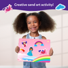 Young girl holding pink fairy tale-themed sand art board from Sand-Tastic Art Unicorns & Princesses