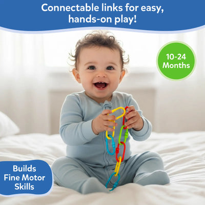 A smiling baby seated on a soft bed holds and explores a colorful chain of plastic links using both hands. The links appear in bright yellow, red, green, and blue. Text above reads “Perfectly sized for tiny fingers,” and a badge indicates suitability for ages 10–24 months. A callout highlights that the toy helps build fine motor skills through hands-on play.
