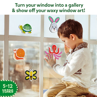 Young boy applying colorful animal-shaped window clings from Waxy Window Art for Kids