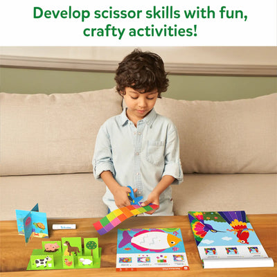 Child using scissors in Snip Snip Amazing Animals craft activity kit for ages 3-7