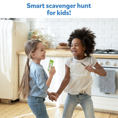 Smiling young girls playing a game in the kitchen with Found It Home Edition scavenger hunt