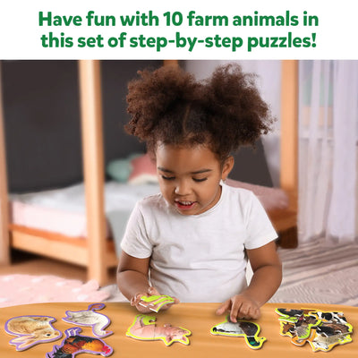 Young child playing with farm animal puzzle pieces from Step By Step Puzzle Farm Animals