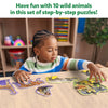 Child assembling animal-shaped puzzles from Step By Step Puzzle Wild Animals for ages 3+