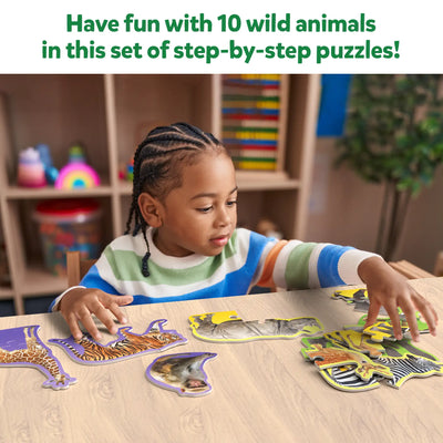 Child assembling animal-shaped puzzles from Step By Step Puzzle Wild Animals for ages 3+