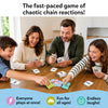 Family of four gathered around a table playing Skillmatics Cross Over. Parents and children hold cards and quickly place matching picture and category cards in the center. Text highlights the fast-paced chain-reaction gameplay with everyone playing simultaneously, making it fun for all ages and full of laughter.