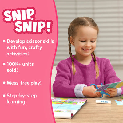 Young girl happily cutting paper with scissors using Snip Snip Unicorns & Princesses craft kit