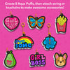 Flat lay of completed Aqua Puffs designs on bright pink background including Girl Power heart, butterfly, fries with heart, rainbow with “awesome,” blue flower, pear with heart, Girl Boss text, and dog face. Each design appears puffed with layered 3D edges and gold keychain attachments. Text states: Create 8 Aqua Puffs and attach string or keychains.