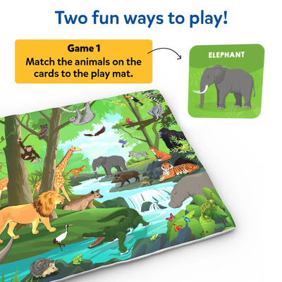 A jungle-themed cloth play mat is shown alongside a green animal card labeled “Elephant.” A yellow text box explains “Game 1: Match the animals on the cards to the play mat.” The mat includes detailed illustrations of a lion, giraffe, elephant, tiger, crocodile, birds, sloth, monkey, and river landscape, demonstrating how children visually match cards to the scene.