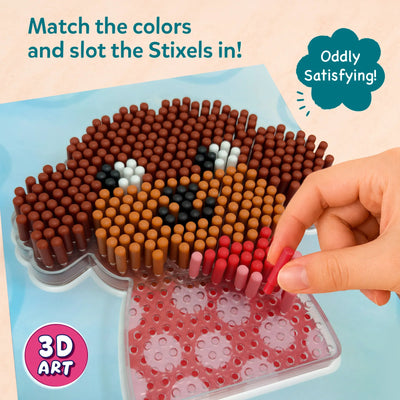 Close-up instructional view of Skillmatics Stixels 3D art activity showing a hand placing a pink stixel peg into a transparent base board to form a puppy face design. The image emphasizes color matching, slot-and-fill technique, with cylindrical pegs creating a textured mosaic effect.
