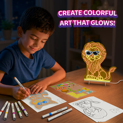 Child using the Skillmatics Light-Up Sketcher at a table, coloring an animal design with markers beside tracing sheets and a reusable sticker sheet. A completed lion-shaped board glows on an LED stand nearby, illustrating colorful illuminated artwork created with the kit.