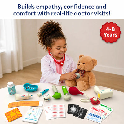 Young child dressed as a doctor uses a toy stethoscope to examine a teddy bear while seated at a table with Skillmatics Doctor Set accessories. Visible items include a thermometer, syringe, pulse oximeter, medicine bottle, blood pressure monitor, X-ray sheets, bandages, stickers, and prescription pad.