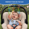 A baby seated in a padded stroller reaches upward to grasp colorful plastic Linkies attached along the curved stroller handle. The links appear in red, green, blue, yellow, and orange, hanging at different lengths. A blue banner at the top reads “Perfect for on the go,” illustrating how the links can be used as a portable activity during outdoor travel.