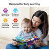 A mother and baby sitting together indoors, looking at and holding the Incy Wincy Spider sensory cloth book. The baby touches the soft pages while the parent supports the book. Icons and text highlight early learning benefits such as boosting fine motor skills, enhancing vocabulary, developing curiosity, and promoting sensory awareness. The scene emphasizes bonding, shared reading, and tactile exploration through soft fabric pages.