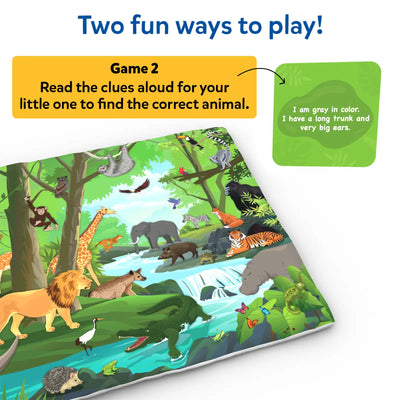A jungle-themed play mat is displayed with a green clue card containing simple text clues about an animal’s appearance. A yellow instruction box reads “Game 2: Read the clues aloud for your little one to find the correct animal.” The mat shows forest animals such as an elephant, tiger, giraffe, crocodile, birds, and lush greenery with a flowing river.