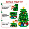 Skillmatics Poke-In Art Christmas Tree decoration guide showing three steps: choose and stick glitter ornaments onto the tree, make and place the mini gift boxes, and add the golden star on top. A fully decorated green tree with colourful ornaments and gift boxes is shown at right.