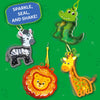 A green background displays multiple animal-shaped foam keychains filled with glitter confetti, including a crocodile, zebra, lion, and giraffe. Each figure is attached to a small loop and appears mid-shake, with motion lines and sparkle highlights. A blue label reads “Sparkle, seal, and shake!” while decorative leaves and light effects surround the hanging animal designs.