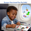 A young child sits at an airplane tray table smiling while coloring stickers with markers. Text at the top reads “Screen-free travel fun for kids!” The window beside the child shows static stickers clinging to the glass. A “Mess Free!” badge appears in the corner, highlighting portable, quiet, and creative play during travel without screens.
