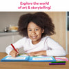 Young girl with dark curly hair smiling and holding a red marker from My Storybook Art Kit