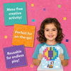 Smiling girl in a blue shirt holds a completed Skillmatics Felt Fun hot air balloon picture board with colorful felt squares on a pink felt background. Three overlapping felt squares display text: Mess-free creative activity, Perfect for on-the-go, and Reusable for endless play.