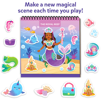 Skillmatics Peelies Royal Reef mermaid habitat scene in a spiral-bound book surrounded by loose reusable stickers. The book shows a mermaid princess with a crown and wand, narwhal, clownfish, jellyfish, seahorse, sandcastle, and bubbles in an underwater scene. Surrounding stickers include a narwhal, mermaid tail, seahorse, shell, pink fish, mermaid in clamshell, tiara, handbag, and sandcastle. Text reads Make a new magical scene each time you play.