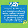 Blue and green background graphic showing Skillmatics Spinny Gears logo and a detailed description of the product. The text explains that the toy encourages STEM learning, builds fine motor skills, and teaches cause-and-effect through hands-on play. A small illustrated caterpillar character decorates the bottom right corner, reinforcing the playful and educational nature of this toddler toy.