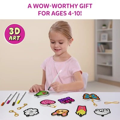 Young girl seated at table coloring green pear Aqua Puff with water pen. Spread across table are butterfly, Girl Boss, fries, dog face, rainbow and flower designs, along with markers, keychain clips and string. Header reads “A WOW-WORTHY GIFT FOR AGES 4–10!” with circular badge stating “3D ART.”