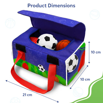 Blue fabric sports bag shown open with plush soccer, basketball, and cricket balls inside. Measurement arrows indicate product dimensions, showing a length of 21 cm and height and depth of 10 cm each. The bag features red carry handles, printed sports graphics on the sides, and visible Velcro tabs, clearly illustrating size and structure.