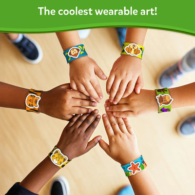 Children’s hands wearing colorful animal-themed Snap Bandz bracelets for DIY craft activity