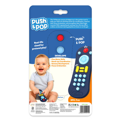 Back-of-pack image of the Skillmatics Push & Pop TV Remote toy showing educational benefits and baby-safe design. Features icons for fine motor skills, sensory development, and focus. A baby is shown playing with the remote. Text notes BPA-free materials and real-life sizing for pretend play. The design highlights developmental learning for infants.