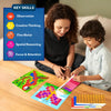 Adult woman and young boy sit at a wooden table working on a felt mosaic animal craft. The child presses a colored felt square onto a butterfly picture board while another completed macaw board lies nearby. Felt sheets labeled butterfly, snail, macaw, and leopard rest beside them. A blue panel titled “Key Skills” lists observation, creative thinking, fine motor, spatial reasoning, and focus and attention.