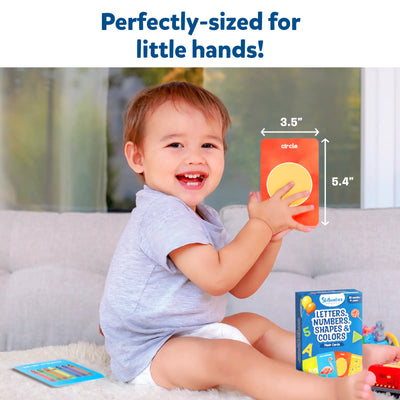 Toddler holding an orange flashcard with a yellow circle from Flash Cards for Toddlers