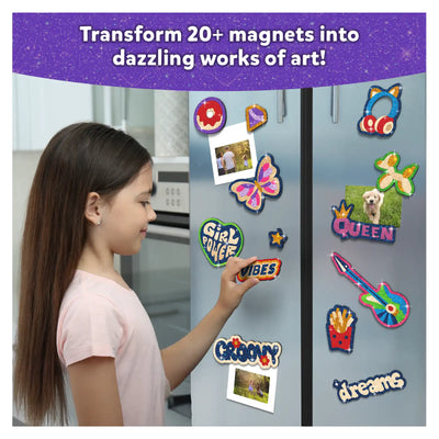 Girl placing colorful glittery magnets on refrigerator with Foil Fun Girl Power Magnetic Art Kit