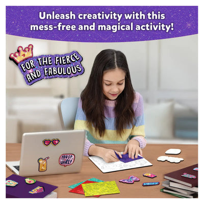 Young girl crafting with glitter and stickers using Foil Fun Girl Power Magnetic Art Kit