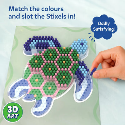 Close-up of the Skillmatics Stixels Sea Turtle project showing colorful Stixels inserted into a transparent turtle-shaped base. A hand places a blue Stixel into an open slot while the completed design features green, pink, blue, and yellow details, creating a textured 3D artwork.