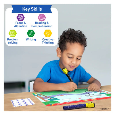 Young boy using light-up pen on Disney Junior Mickey Mouse reusable activity mat for learning
