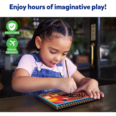 Young girl drawing in a travel-friendly magical scratch art book for kids ages 3-8