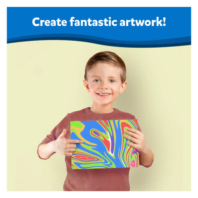 Smiling young boy holding vibrant swirled artwork from Artsy Explorers Bundle