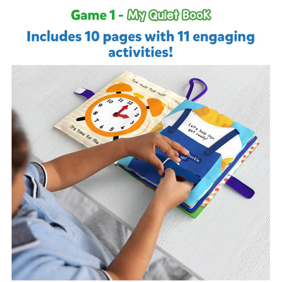 Child playing with a colorful soft quiet book featuring an alarm clock and overalls