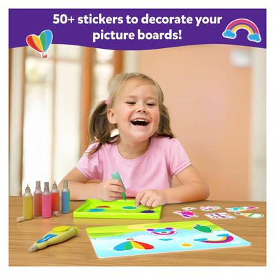 Young girl happily creating colorful sand art with pens and stickers from Sand-Tastic Art