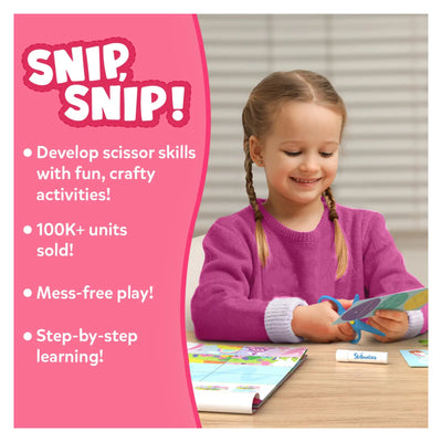Young girl happily cutting paper with scissors using Snip Snip Unicorns & Princesses craft kit