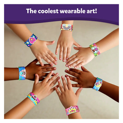 Children’s hands wearing colorful decorative slap bracelets from Snap Bandz Unicorns and Princesses
