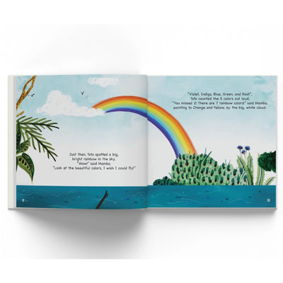 Open children’s storybook showing vibrant rainbow over water and land for Mambo & Toto go Boating